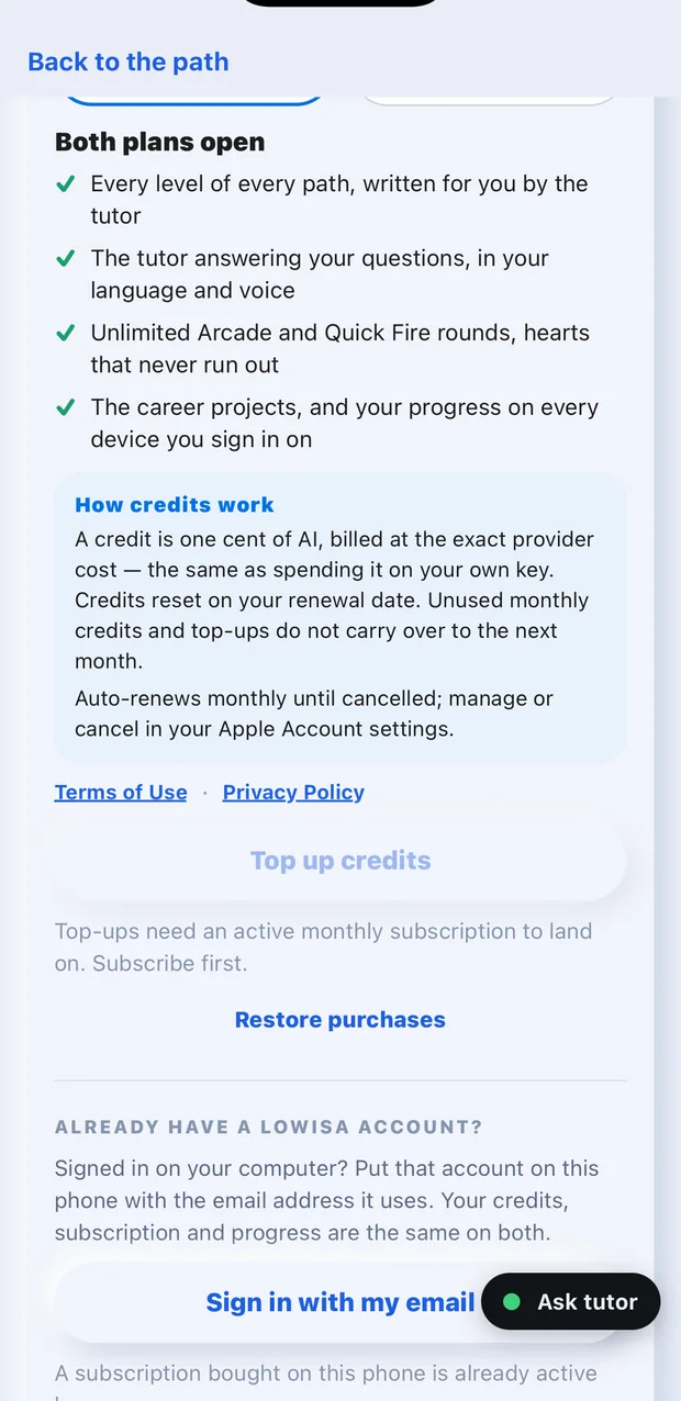 The lower half of the tutor credits screen in the LoWisa app: what both plans open, how credits work, Terms of Use and Privacy Policy, Top up credits, and the Restore purchases button.